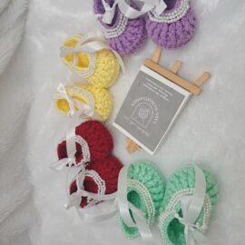 Crochet baby girl booties with beads.